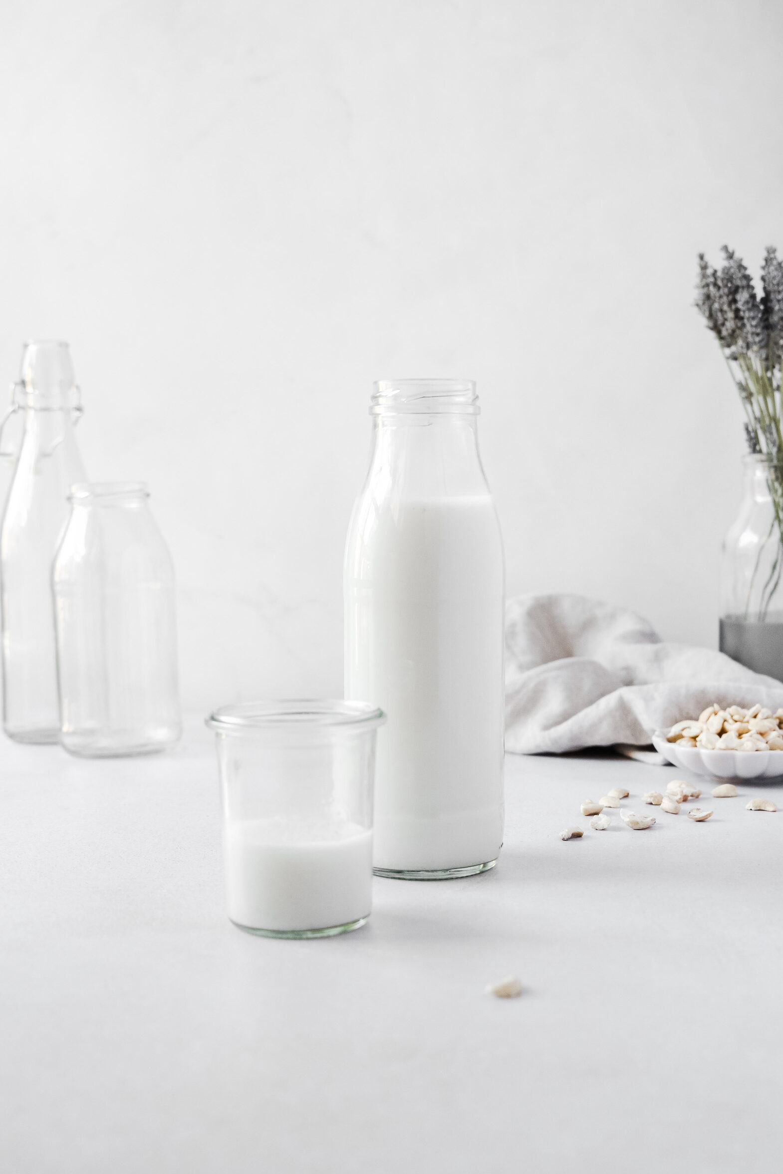 Nut milk bottle and weck jar on white background