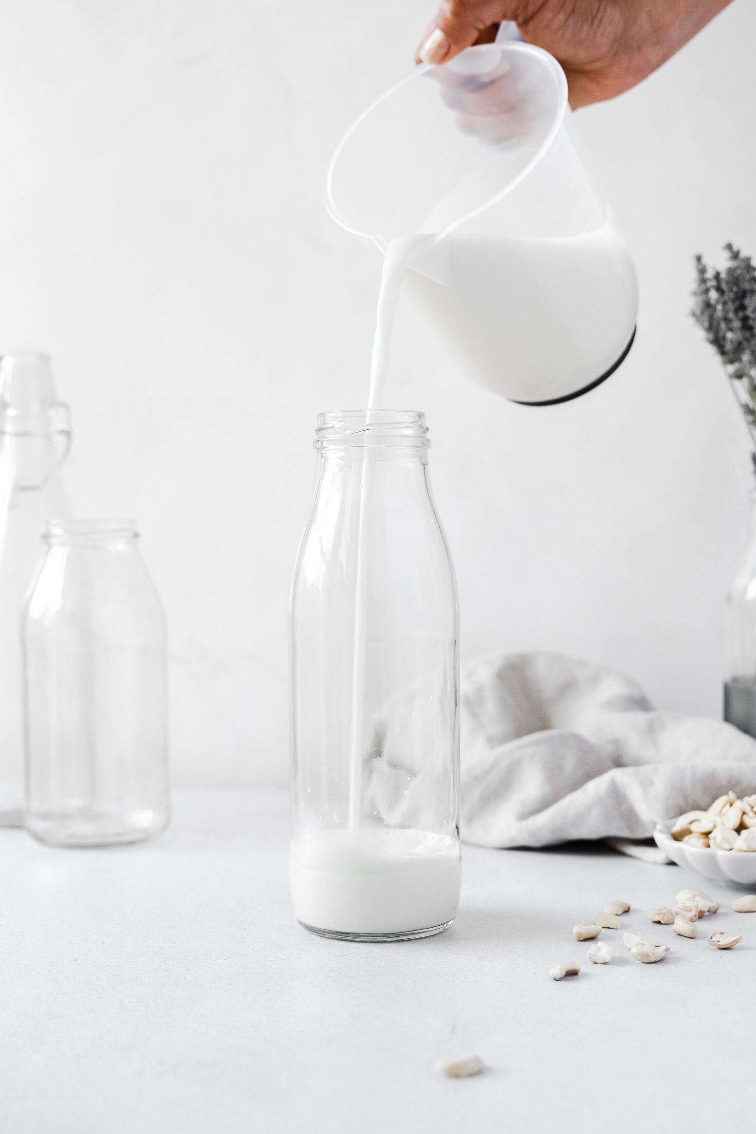 Nut milk bottle and weck jar on white background