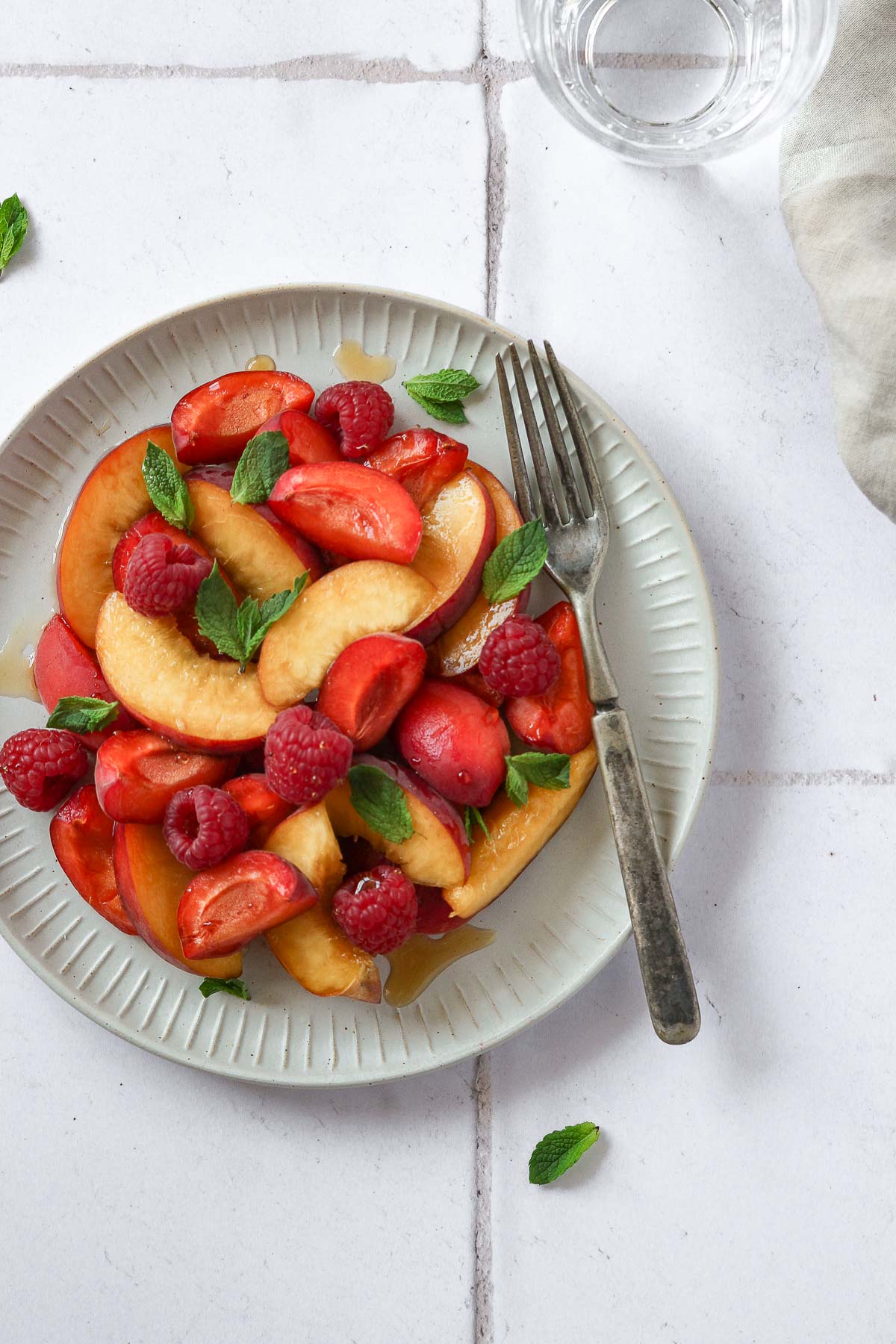 fruit salad on grey plate with vintage fork