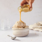 pouring caramel sauce on healthy nice cream