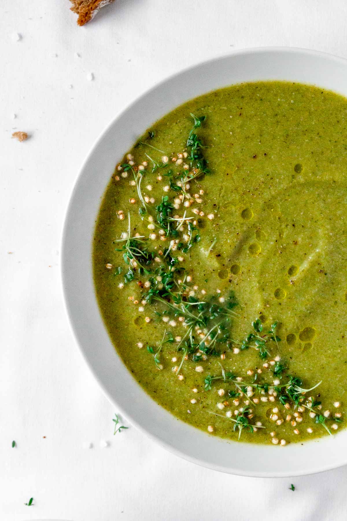 vegan broccoli soup with vintage spoon on white background.