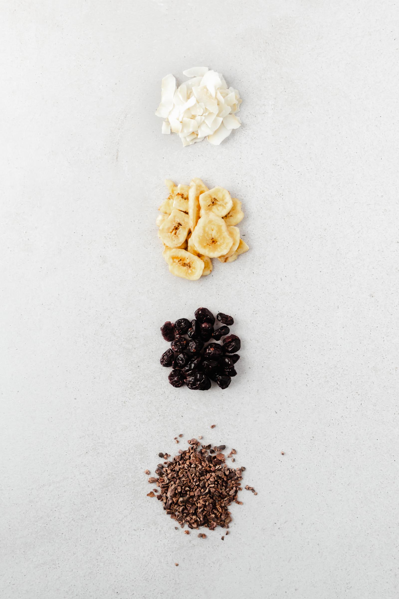 add-ins for almond granola after baking on grey background.