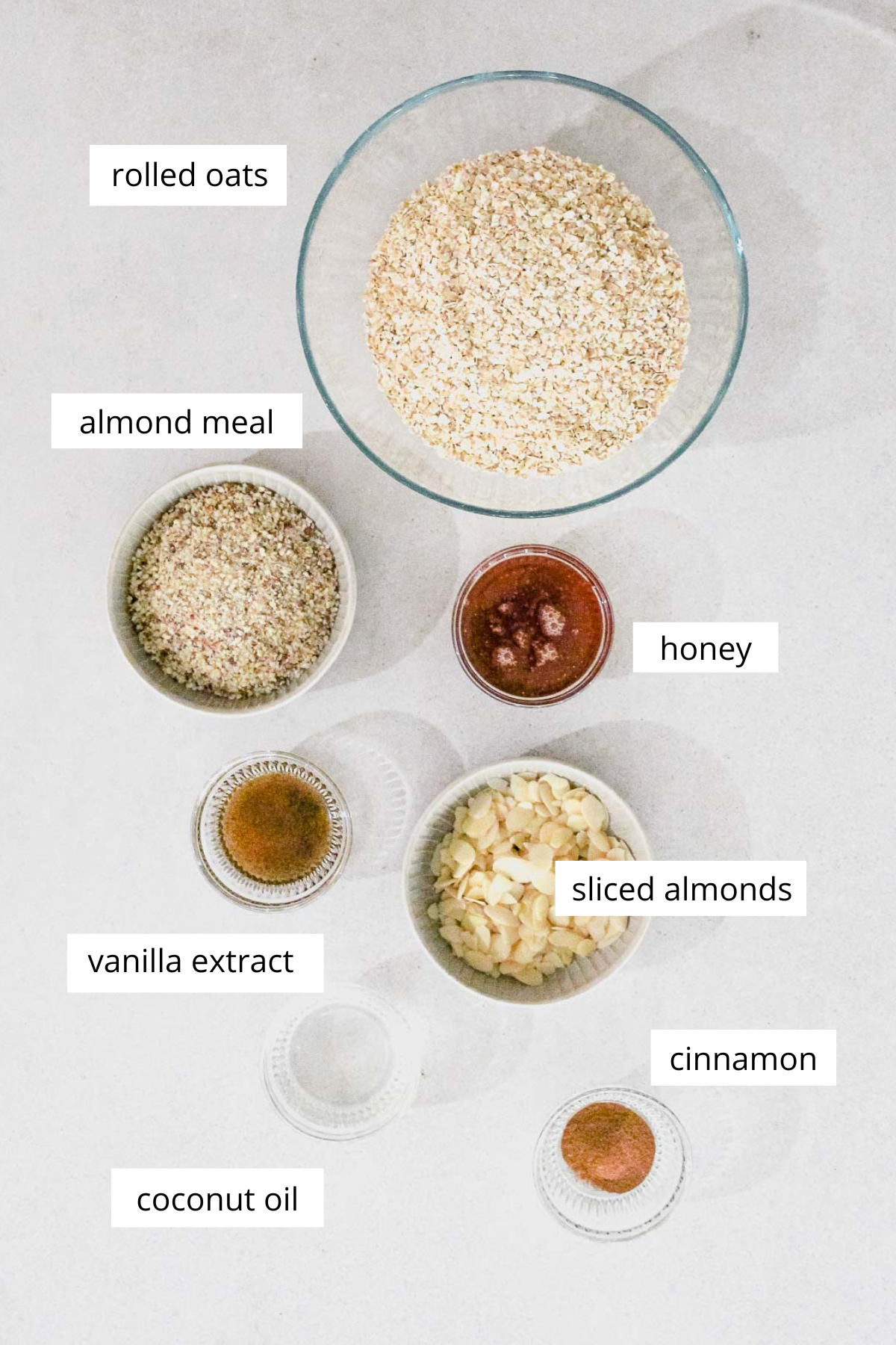 ingredients for almond granola on grey background.