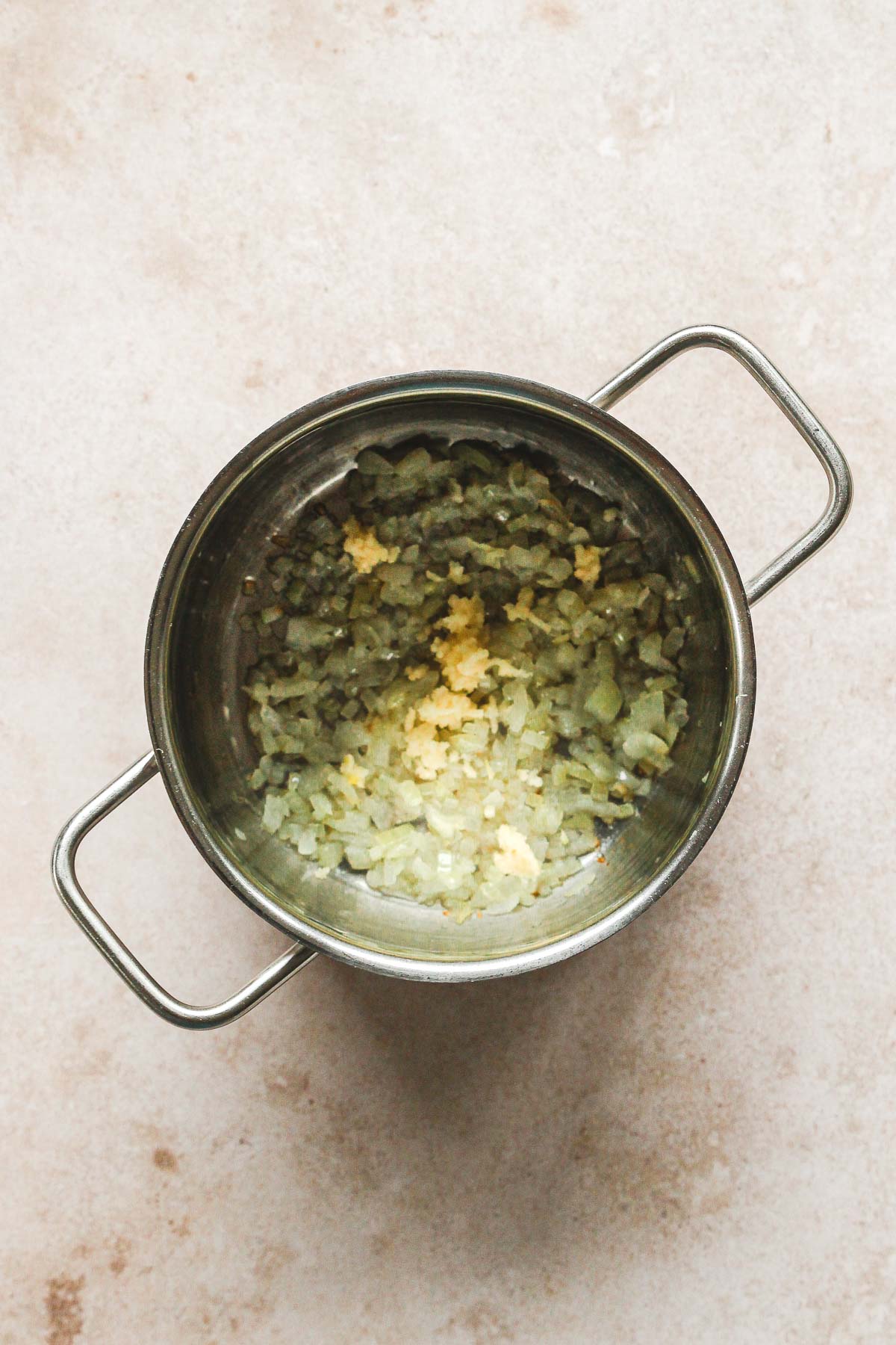 onion and garlic roasting in pot for sauerkraut.