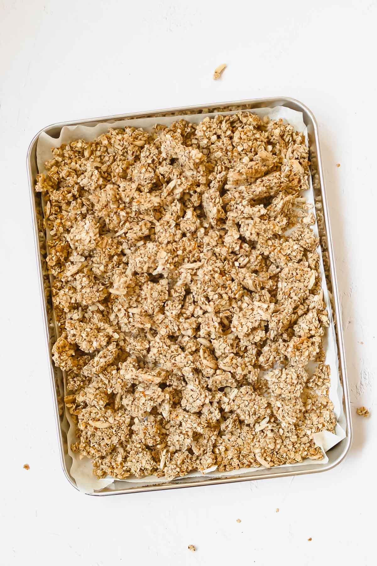 holiday spiced granola on baking sheet with vintage serving spoon.