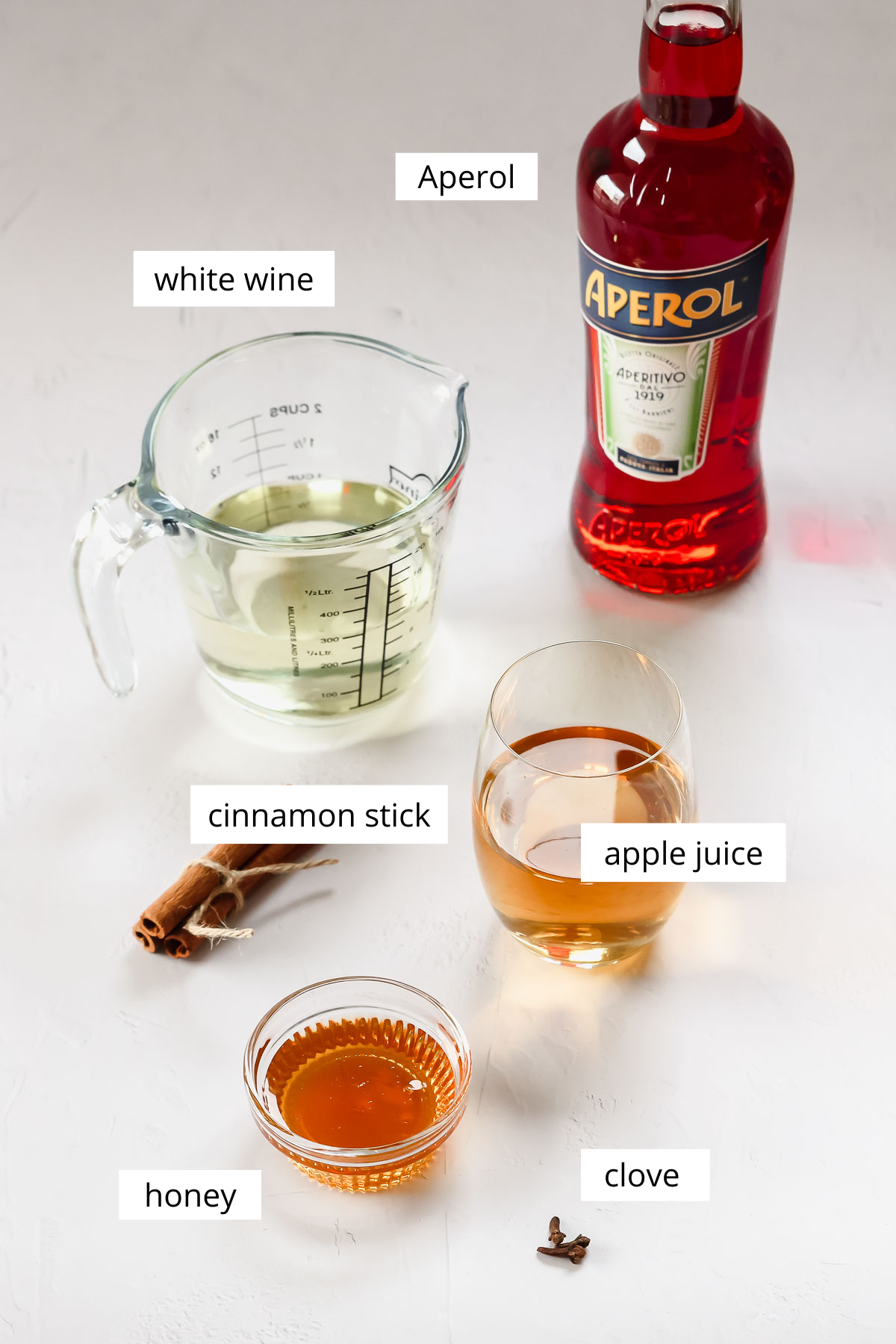 ingredients for hot aperol on grey white background.