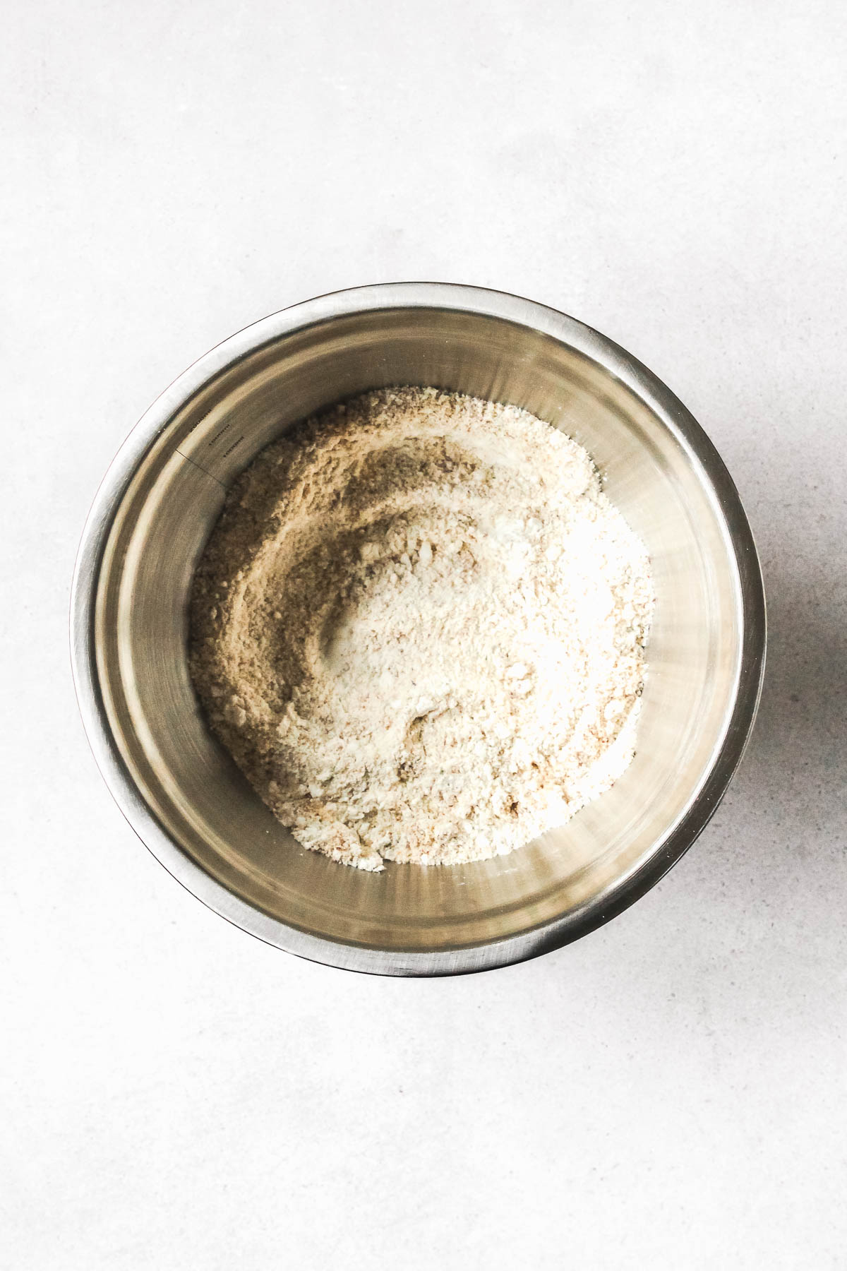 dry ingredients for linzer cookies in metal bowl.