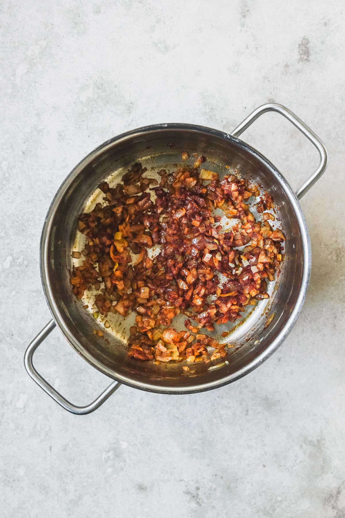 onion, garlic, tomato paste, sweet paprika, cumin and chilli roasting in pot.