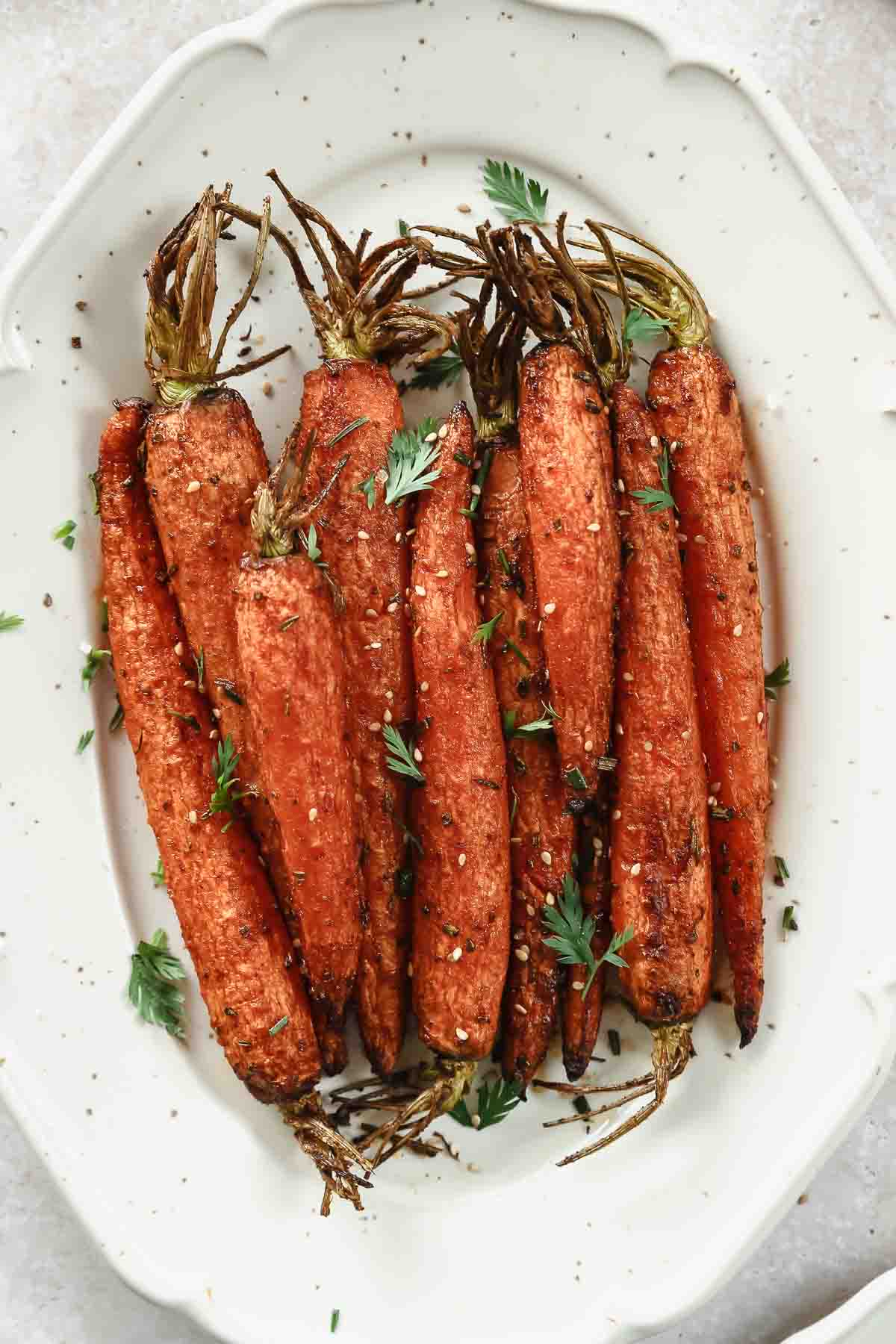 closeup of air fryer crispy carrots on serving platter.