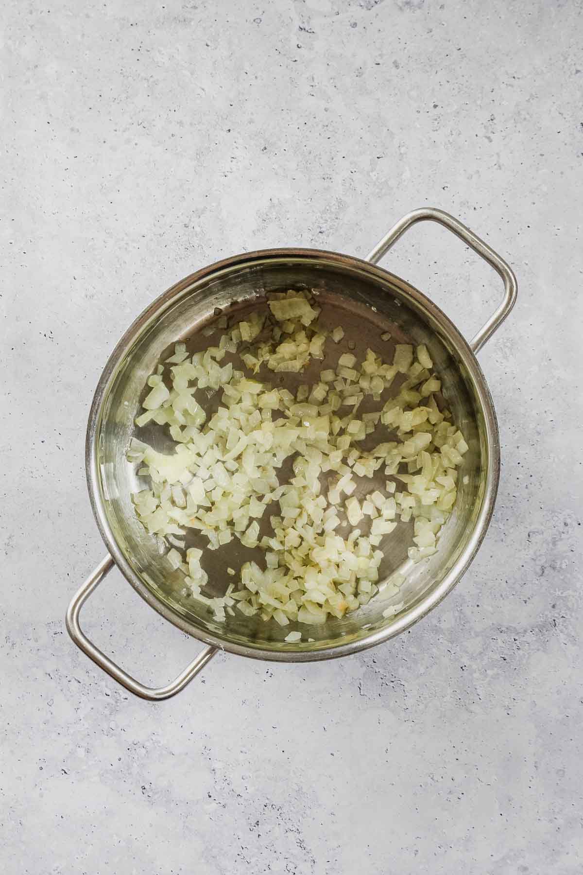 chopped onions roasting in pot.