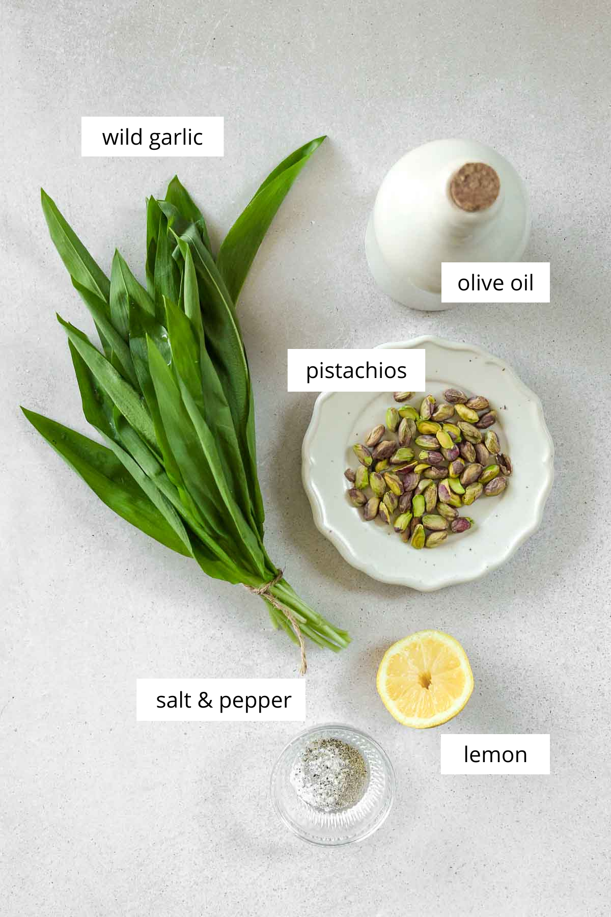 ingredients for vegan pesto with wild garlic on a grey background.