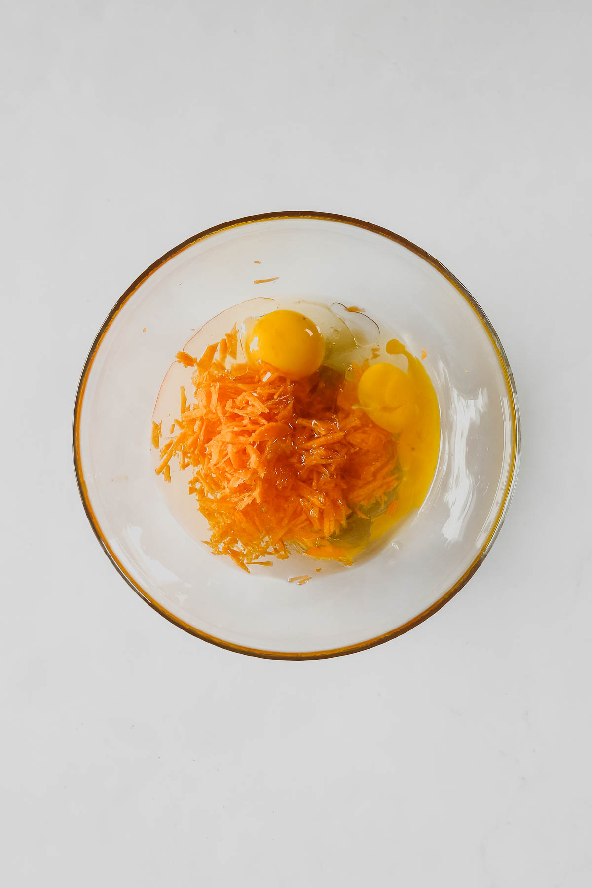 wet ingredients for carrot cake muffins in a glass bowl.