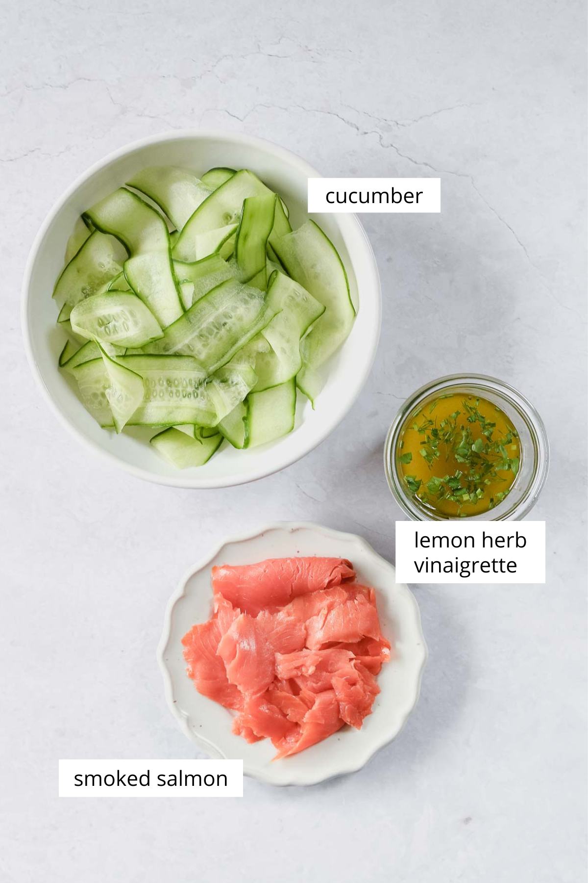 ingredients for smoked salmon salad on grey background.