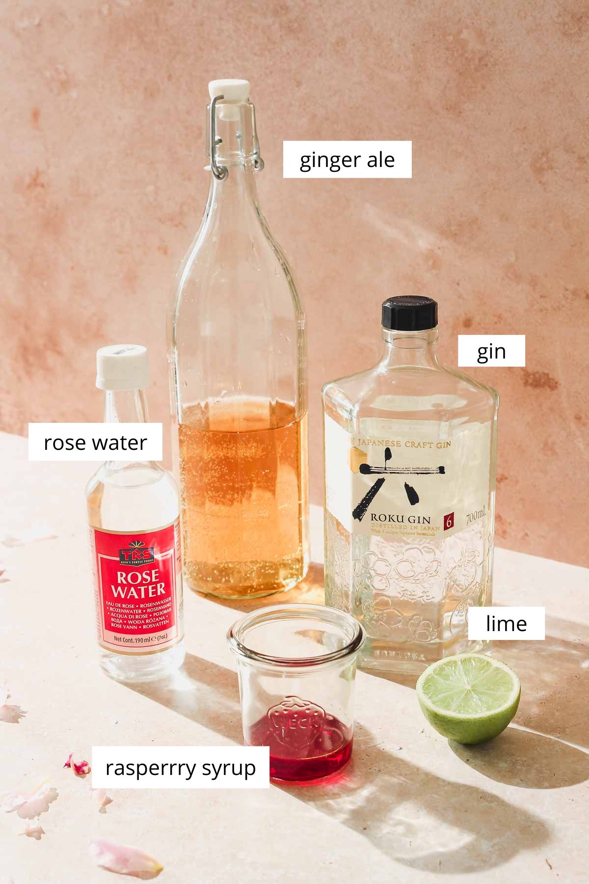 ingredients for floradora cocktail on beige background.