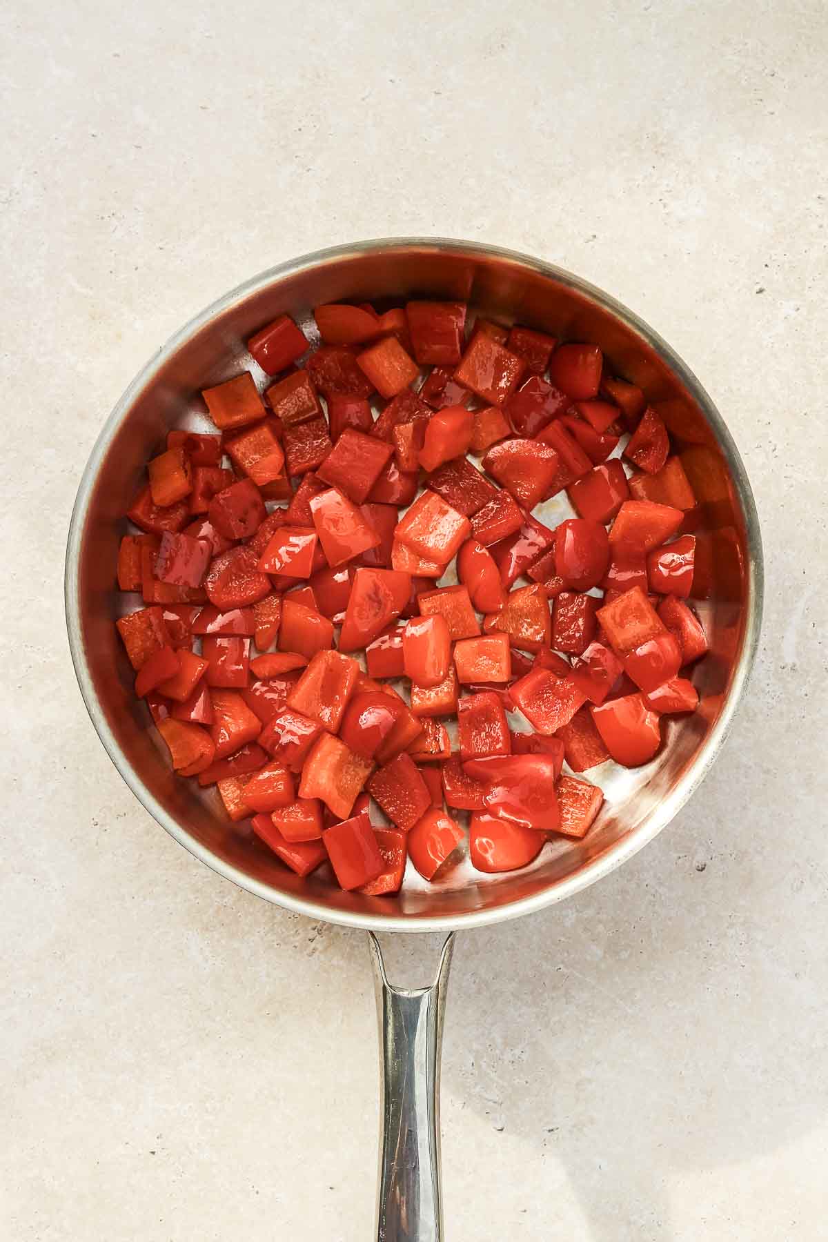 roasting chopped red bell peppers in skillet pan.