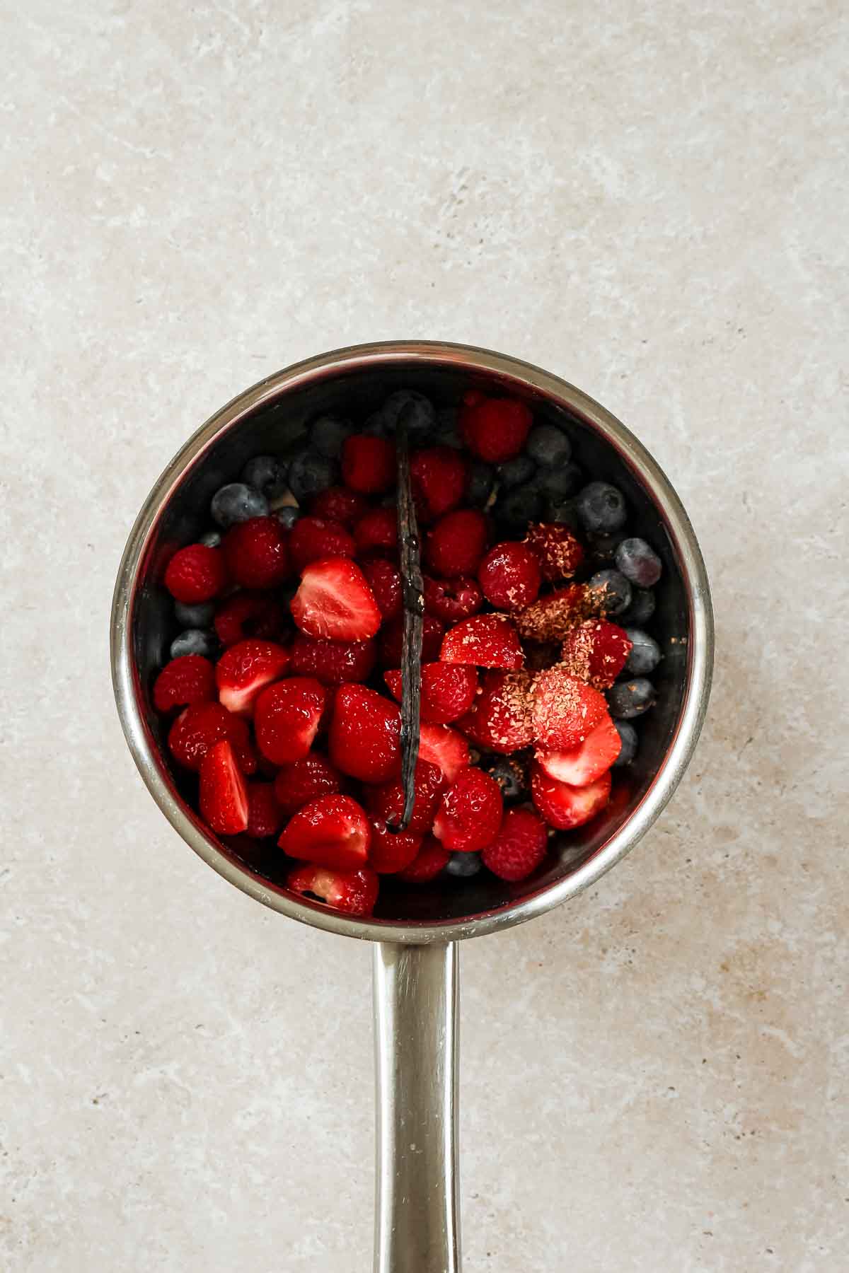 berries, vanilla bean, agave syrup and cardamon in saucepan for berry compote.