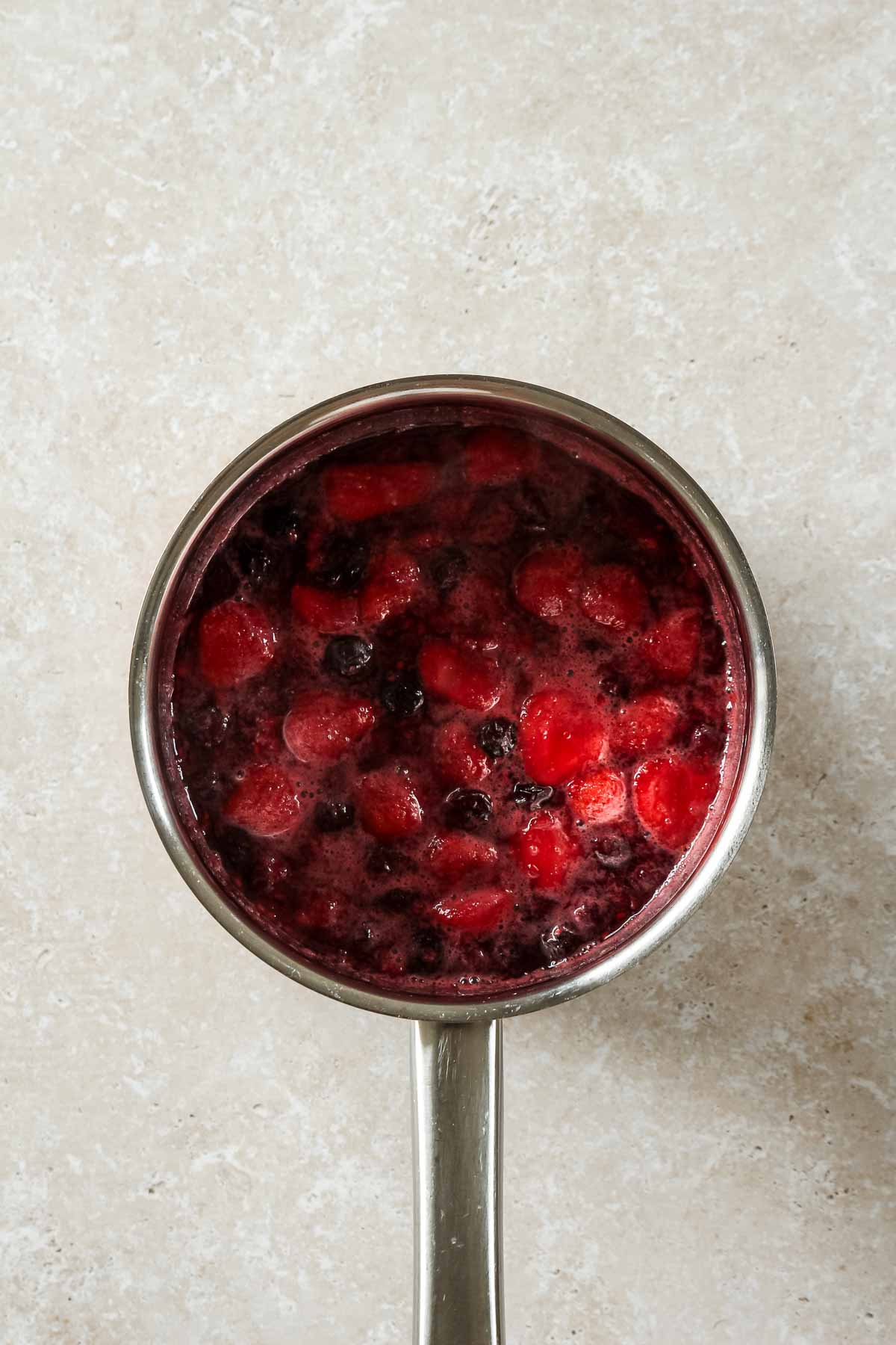 easy cooked berry compote in saucepan.
