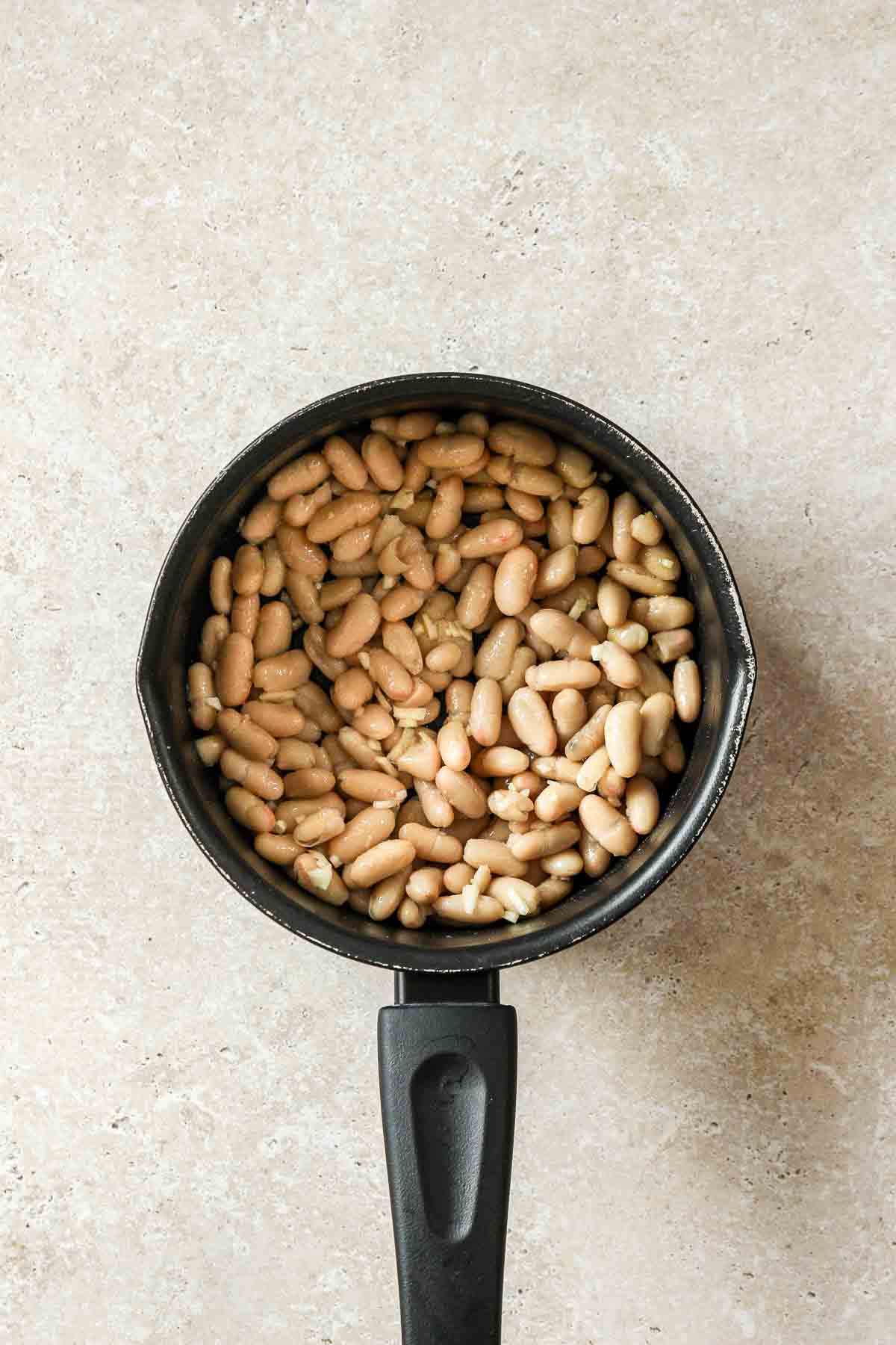 olive oil, white beans and minced garlic in non-stick saucepan.