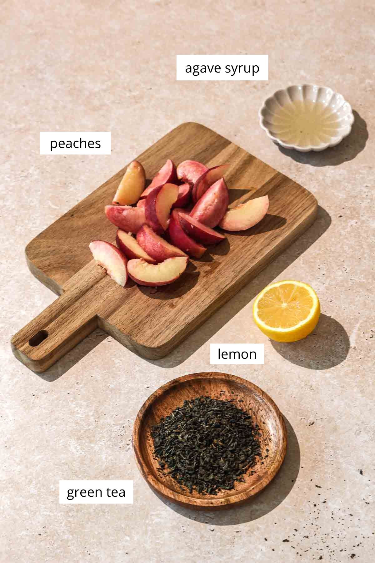 ingredients for peach iced tea on beige background with labels.