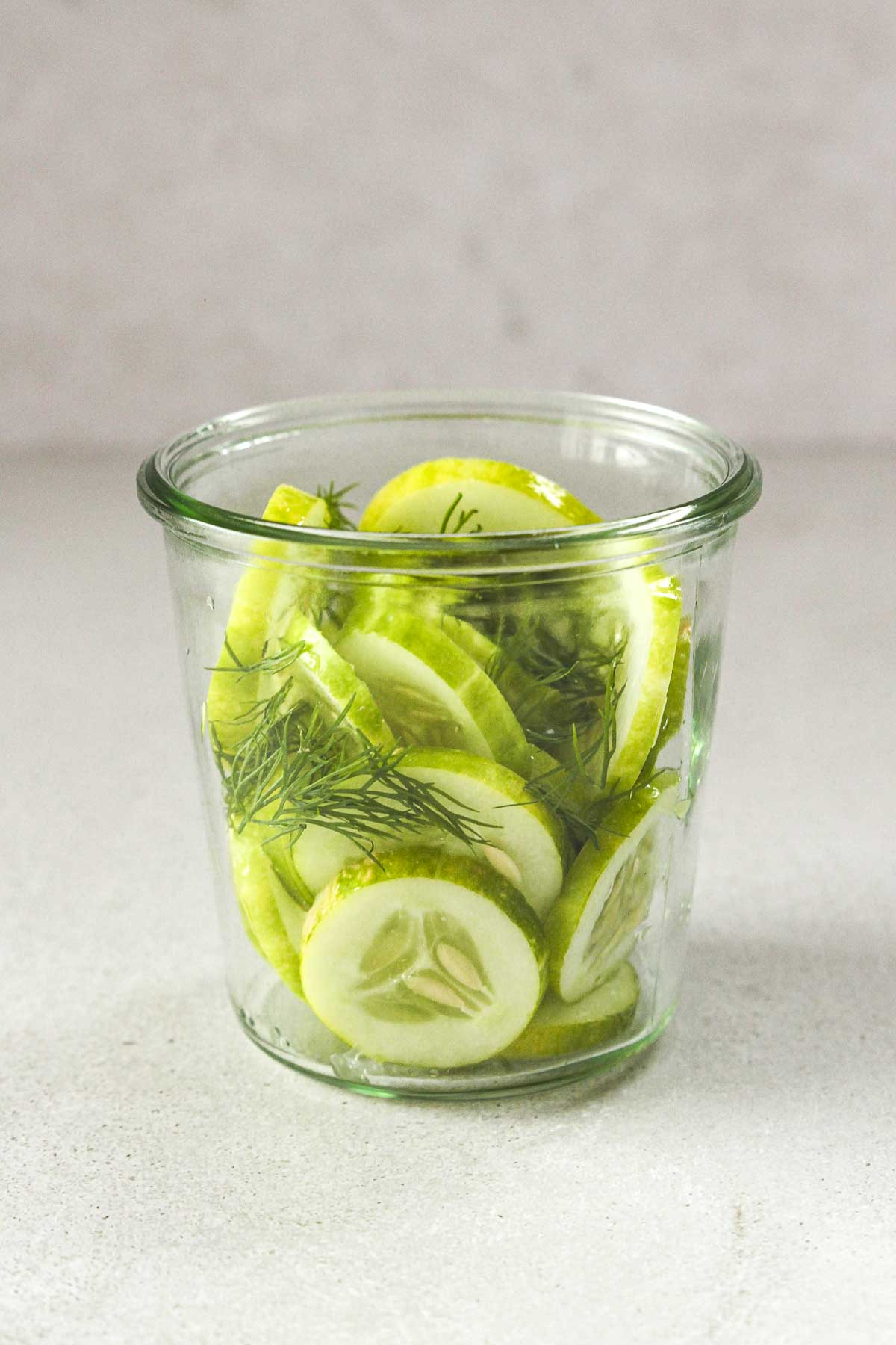 fresh cucumber slices and dill in weck jar.