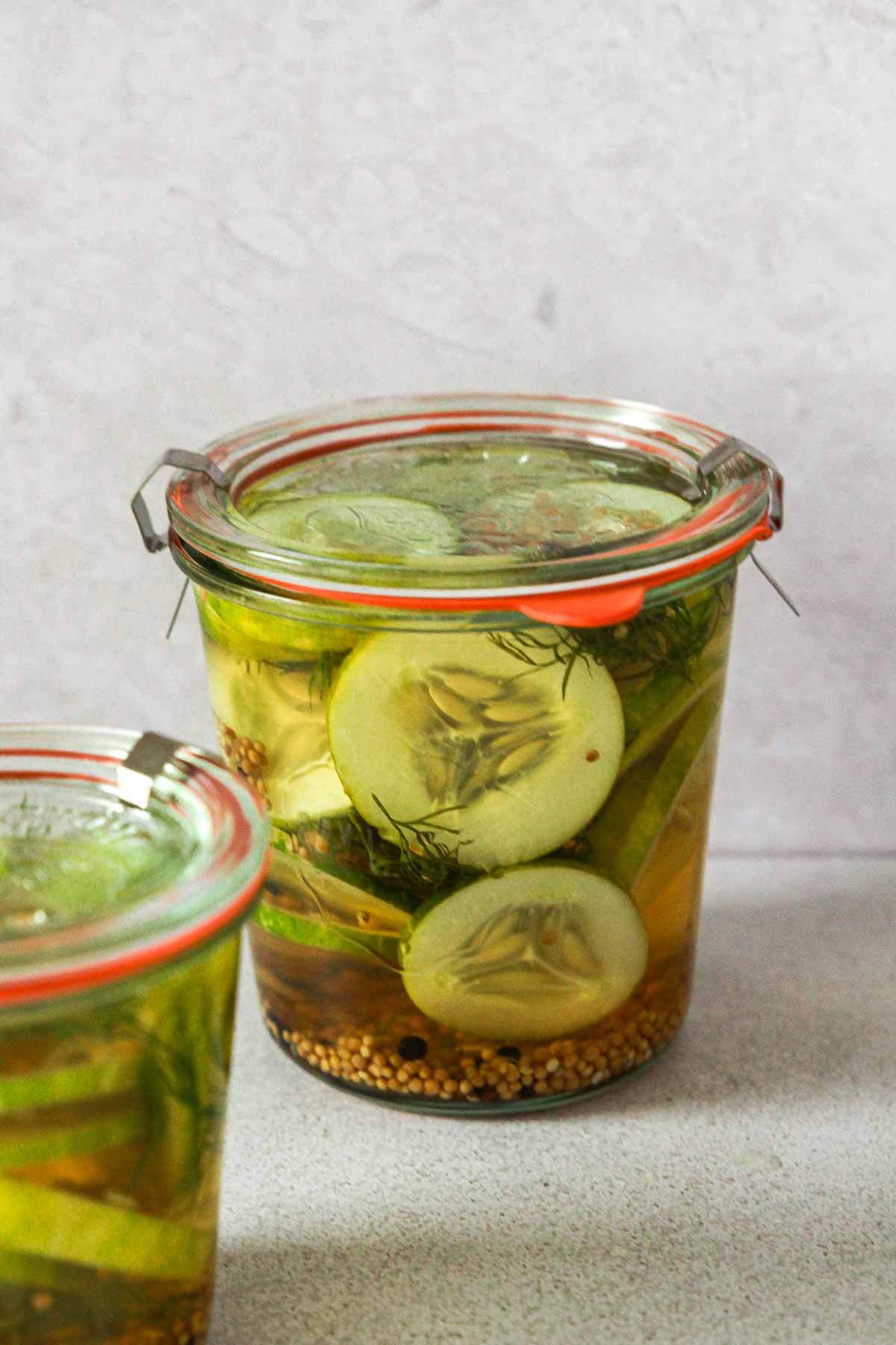 weck jar with infused cucumber slices.