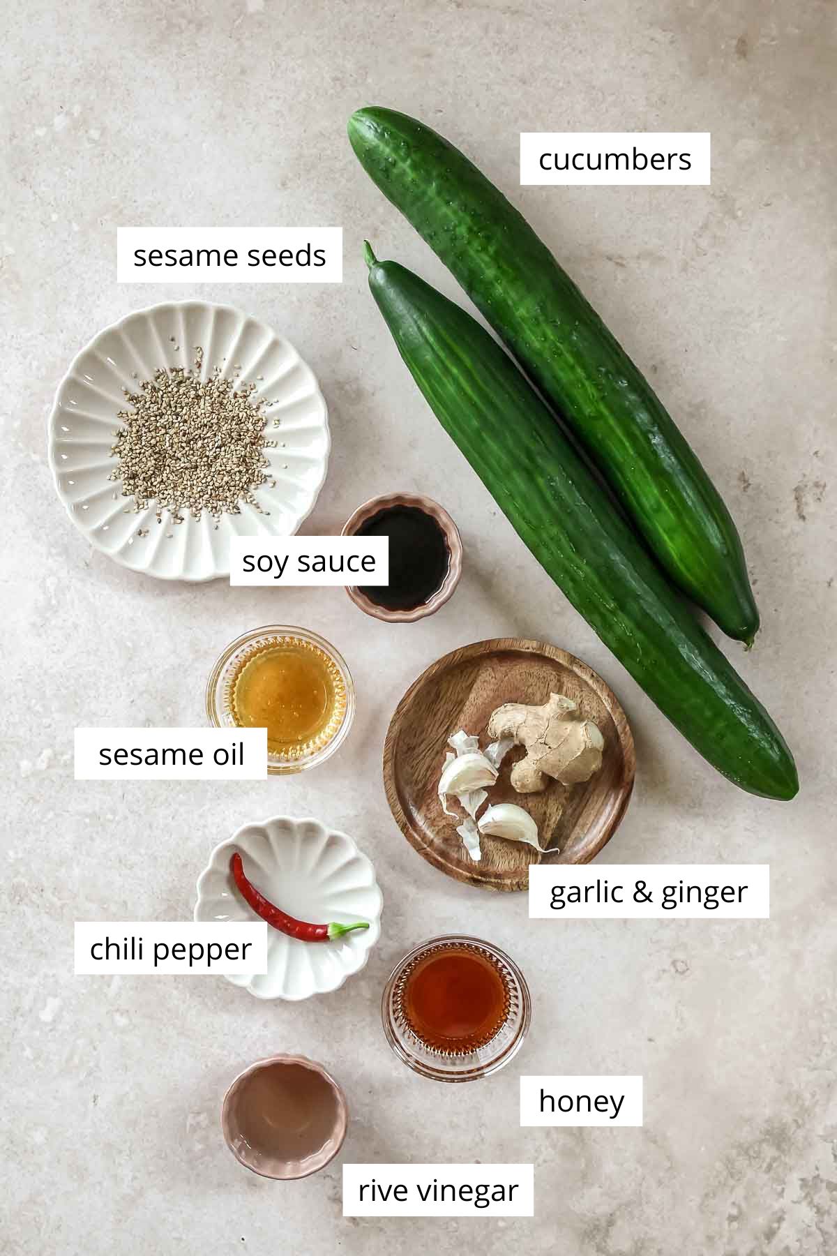 ingredients for smashed cucumber salad on beige background with labels.